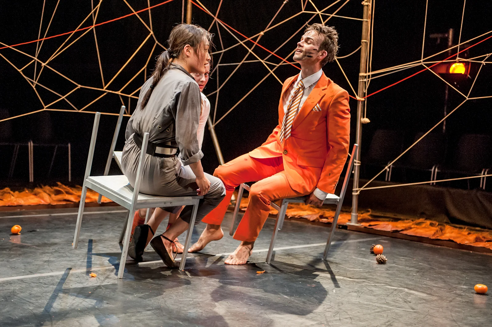 Barrowland Ballet performers in Tiger Tale, with an orange-suited dancer among a web of ropes.